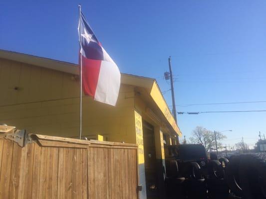 Texas flag flying in the wind.