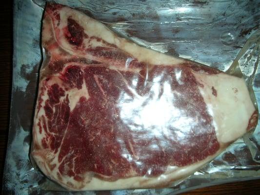 What they call a "hand trimmed T-Bone Porterhouse".  Note the sliver of meat on the filet side and gargantuan hunk  o' fat.