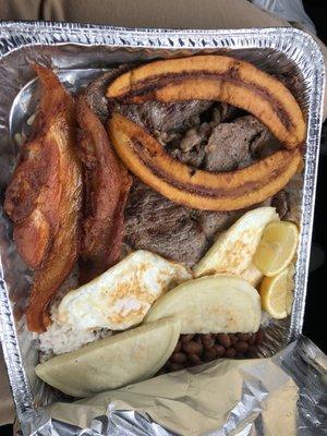 Full-sized bandeja paisa to-go. Arepas, rice, beans, two eggs, chicharrones, maduros, and carne asada.