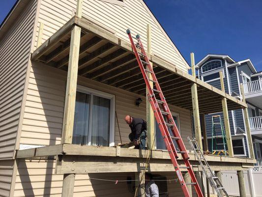 Converting old deck to new fiberglass one, installing new vinyl rails and soffit on 1st floor deck ceiling. Seaisle City, NJ.