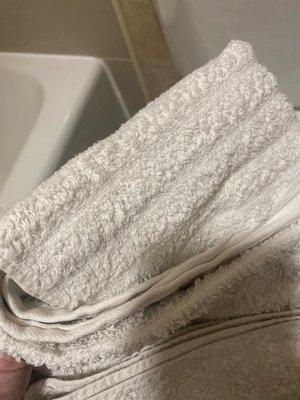 Dirty used towels on shelf