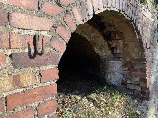 Beehive oven with door hanging hardware still visible.