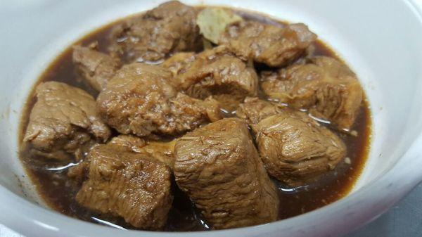 Filipino dish called Pork Adobo. Braised Pork in soy sauce, vinegar, onions, garlic, peppercorn and bay leaves.