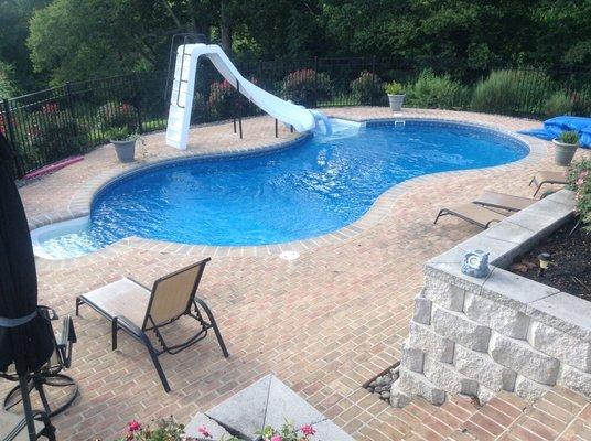 Brick pavers at pool area with retaining wall.