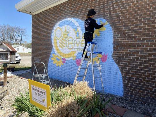 The beginning of change...HIVE Library's new mural (1 of 2) in progress. Katie Lee, KC Muralist, in action. https://www.kcmurals.com