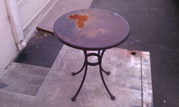 Patio table with rust damage and peeling powedercoat.  We sandblast it to bare metal befor adding new powdercoat