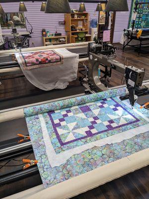 QSL Workshop - quilt tops being quilted on our gammill longarm machines