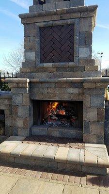 Our outdoor fireplace adds warmth to those cool days!