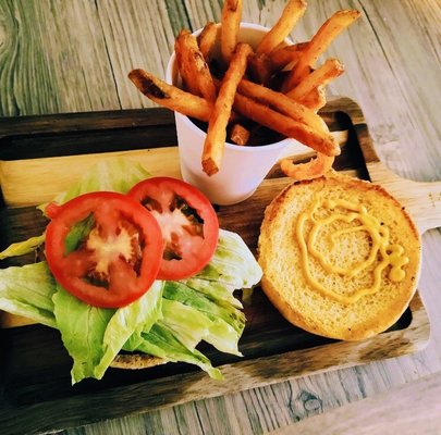 The Classic: Quarter pound vegan patty w/lettuce pickles onions mustard on a sesame seed bun.