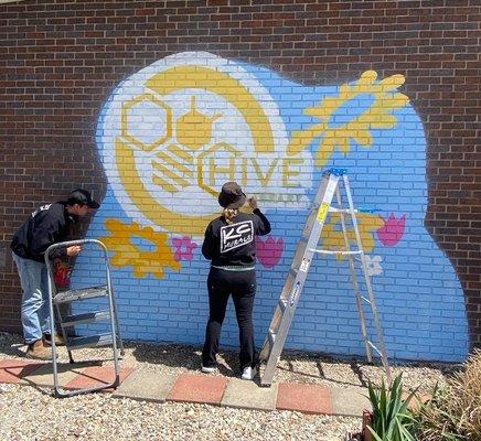 Katie Lee (https://www.kcmurals.com) painting HIVE Library mural 1 of 2.