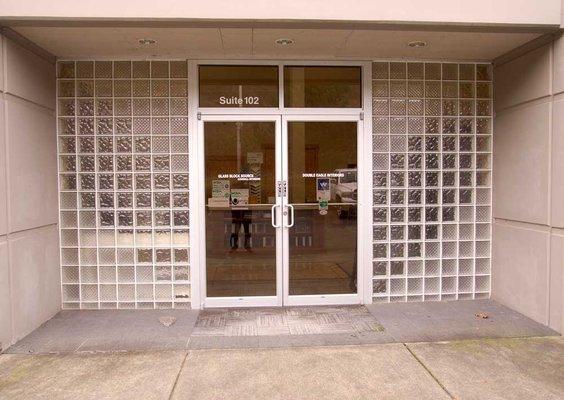 Front door, showing the work of the glass block company they share space with.