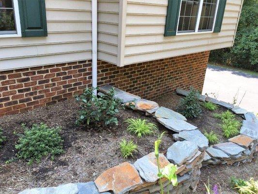 drystack stone wall terracing the grade