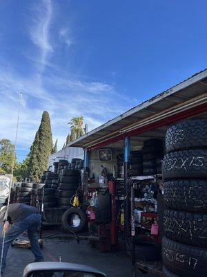 Our view of them working on the tires from inside our car, a pull through experience lined with tires on each side of ya.