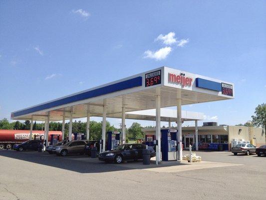 Station view with fuel truck filling the tanks in the background.