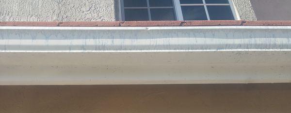 Marks left by M&M Roofing & Roof Cleaning gutter cleaning solution