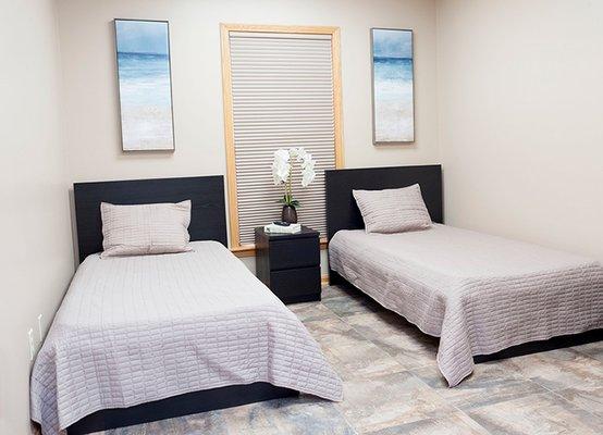 Well-appointed bedrooms at Parkman Recovery Center offer the comforts of home, including flat screen tv.