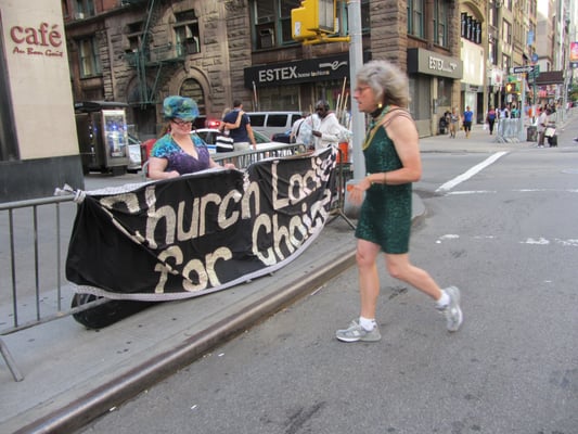 The Church Ladies setting up the sacred Banner.