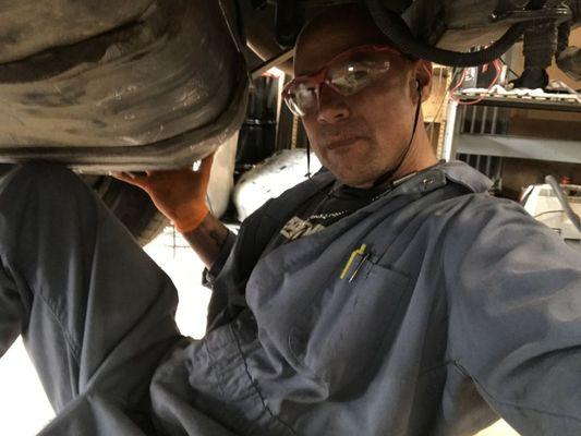 Yours truly under a Chevy pickup replacing the fuel pump..