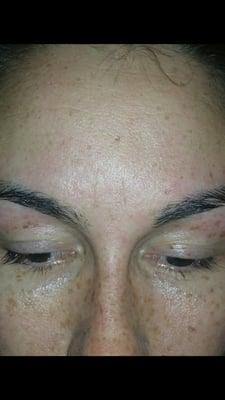 Uneven waxed brows.