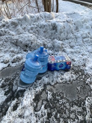 Water delivery left by ReadyFresh driver on the main road in the snow.