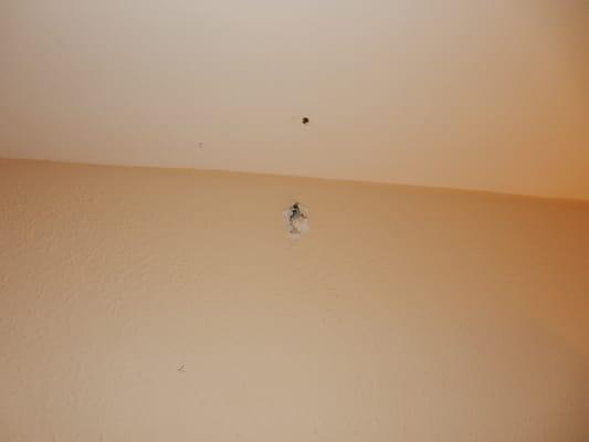 Damage to ceiling and wall during hanging of LCD TV.