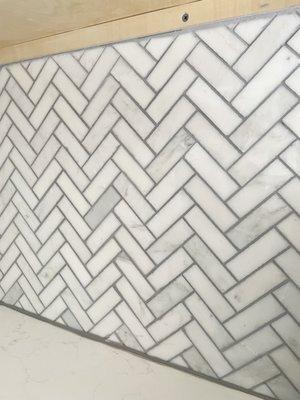 Herringbone marble backsplash