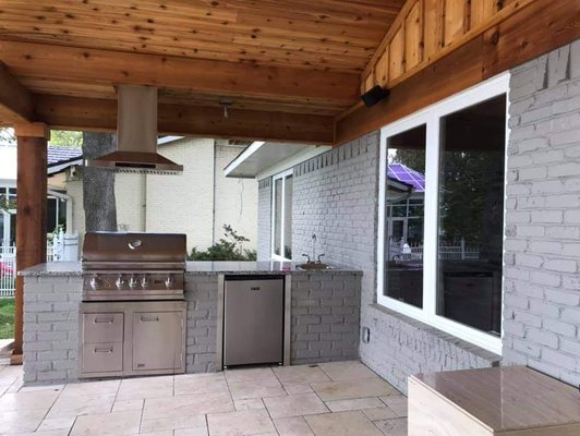 Outdoor Cooking! Yes! Brick Structure with gas gill, refrigerator, and sink.  Ceiling finished out with beautiful cedar wood.