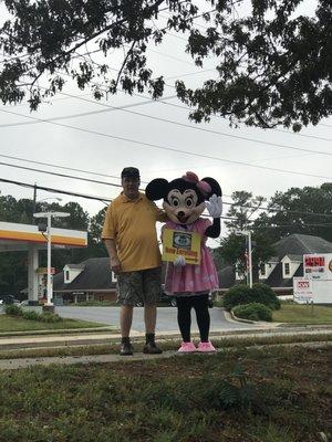 Minnie gets a big hug from a neighbor