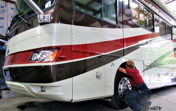 RV Repair Mechanic at work. We offer all types of RV service from oil changes, to engine work, roof repairs, paint and body work and more.