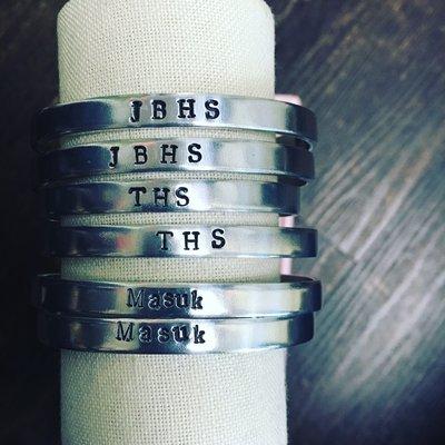 Hand stamped bracelets with local schools. Getting more districts in soon!!