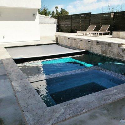 Grey automatic pool cover with flushed tracks