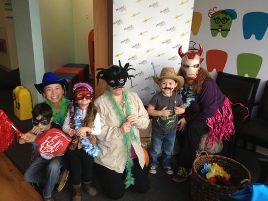 Dr. Lee, and dental assistants carrie and Christina take a pic with the kids at their photo center