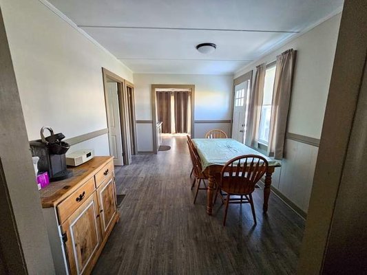 Dining room off of living room bedrooms and bathrooms off of dining room kitchen and another bedroom at the end cottage #3