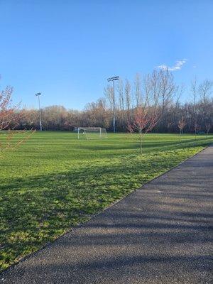 The walking path around the soccer field.