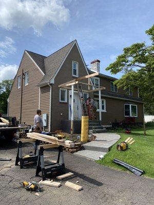 Adding a covered porch for weather protection and curb appeal