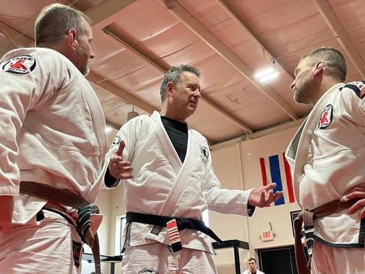 Professor Harvey giving words of wisdom to our newest black belts, Matt and Rob