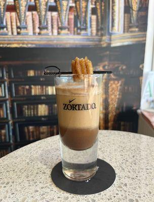 Mocha Zortado with churro. (espresso + steamed cream)