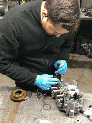 One of our technicians Julian working on a valve body for a CVT Transmission