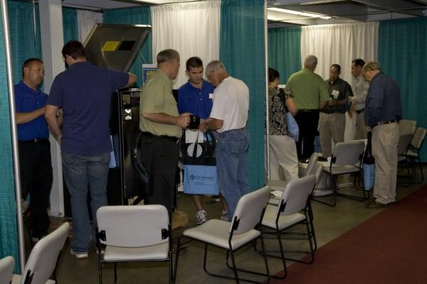 One of our techs teaching customers about the latest machines at our Open House.