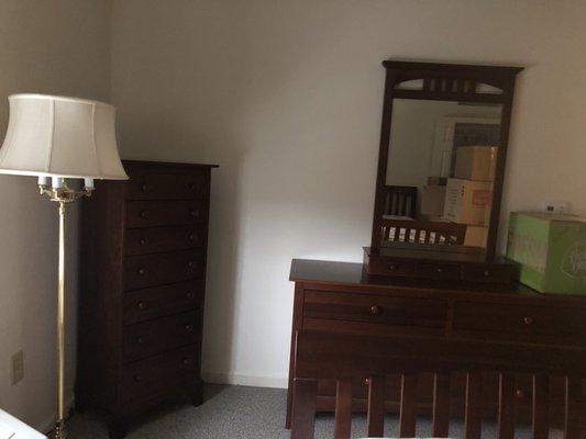 Bedroom mirror carefully reattached to dresser