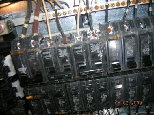 Main electrical panel with rusted breakers. A fire hazard.