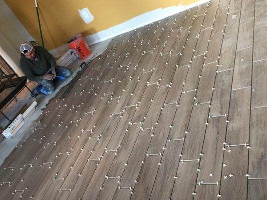 Placing tile on living room.