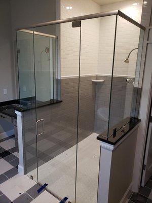 Frameless glass shower enclosure