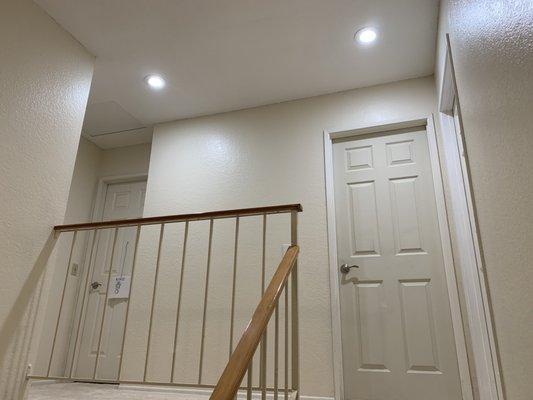 He added two recessed lights and removed the old outdated dim single lamp on this hallway.