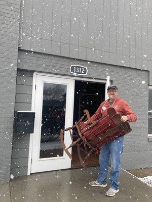 Pastor Alex bringing in rocking chair for nursery