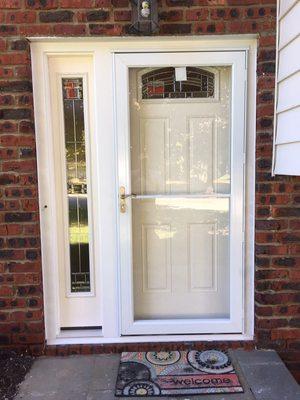 New entry door with sidelight and storm door installed