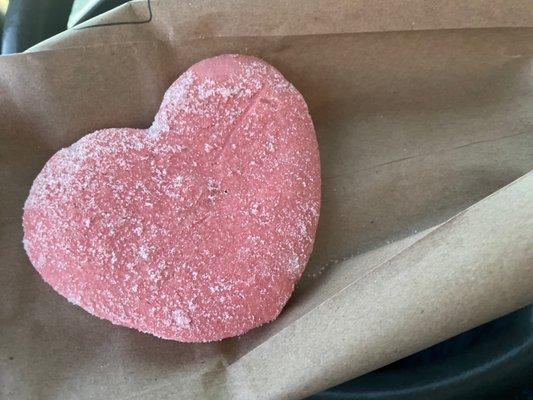 Pink heart-shaped Mexican cookie.