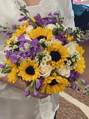 Bridal bouquet w/ sunflowers, vendela roses, purple stock and white aster monte casino.