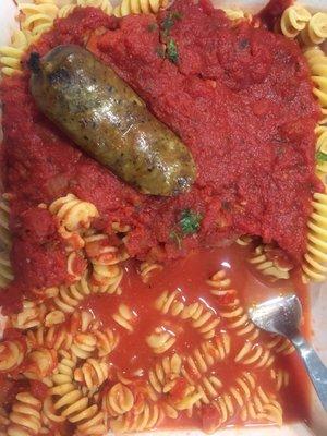 Gluten free pasta with marinara sauce and Italian sausage.