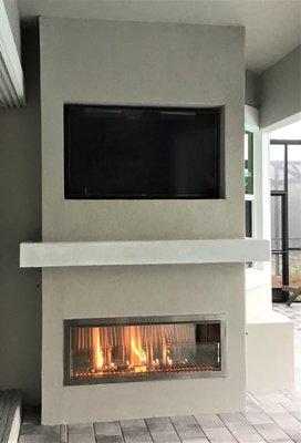 Outdoor gas fireplace, TV and mantle. Naples